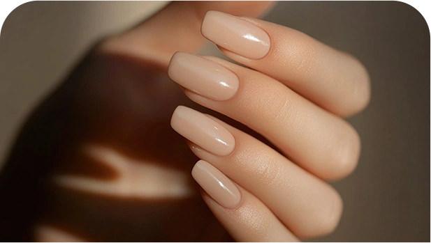 Hand holding pair long pointed pink nails